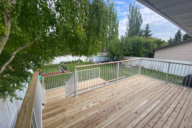 Deck - craftsman backyard second story metal railing deck idea in Other