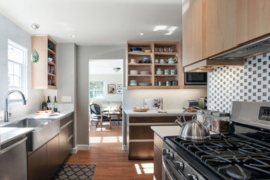 Enclosed kitchen - small modern l-shaped light wood floor enclosed kitchen idea in DC Metro with a farmhouse sink, flat-panel cabinets, dark wood cabinets, quartz countertops, white backsplash, ceramic backsplash and stainless steel appliances