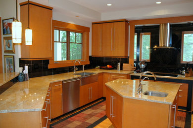 Large trendy u-shaped light wood floor and beige floor kitchen photo in DC Metro with a farmhouse sink, flat-panel cabinets, light wood cabinets, granite countertops, black backsplash, stainless steel appliances and an island