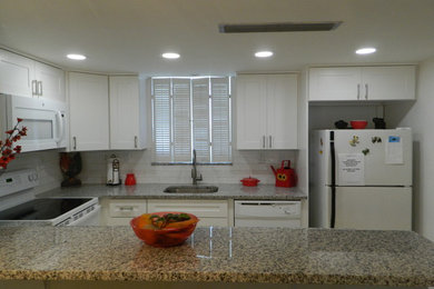 Inspiration for a modern kitchen remodel in Other with shaker cabinets, white cabinets, granite countertops, white backsplash, porcelain backsplash and multicolored countertops