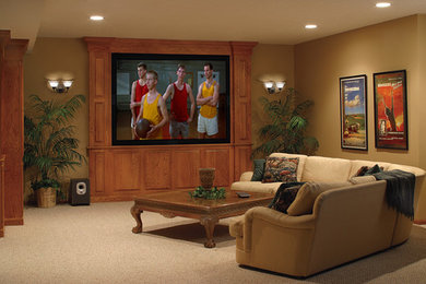 Enclosed home theater photo in Indianapolis with beige walls and a media wall