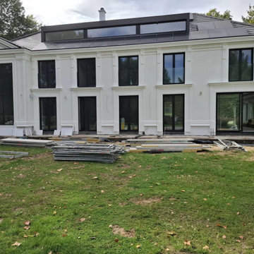 Facade nearing completion, with landscaping still in progress.