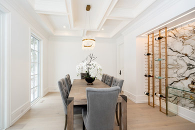 Example of a mid-sized trendy light wood floor and beige floor wine cellar design in Other with storage racks