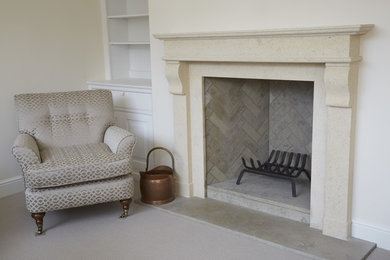 Cream bath stone fireplace with limestone hearth and brickwork