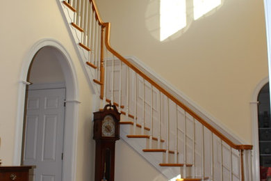 Inspiration for a large traditional foyer in Other with yellow walls and medium hardwood floors.