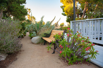 Design ideas for a large rustic drought-tolerant and partial sun backyard decomposed granite and vinyl fence walkway in Los Angeles for summer.
