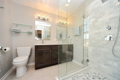Inspiration for a mid-sized contemporary master white tile and subway tile ceramic tile corner shower remodel in Chicago with shaker cabinets, dark wood cabinets, a two-piece toilet, beige walls, an undermount sink and solid surface countertops