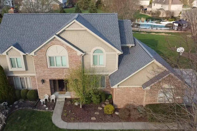 Trendy beige gable roof photo in Indianapolis with a shingle roof and a gray roof
