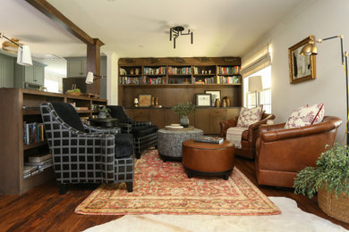 Inspiration for a mid-sized mid-century modern open concept medium tone wood floor and brown floor family room library remodel in Other with beige walls