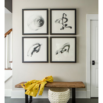 A rustic wood bench offsets the modern abstract art.