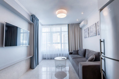 Foto di un piccolo soggiorno contemporaneo aperto con pareti bianche, pavimento con piastrelle in ceramica e TV a parete
