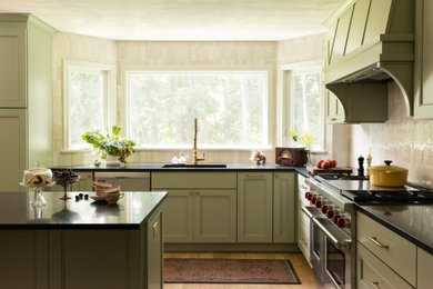 Elegant kitchen photo in Boston with green cabinets, beige backsplash, ceramic backsplash and black countertops