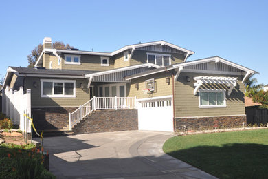 Large elegant brown two-story wood exterior home photo in Orange County