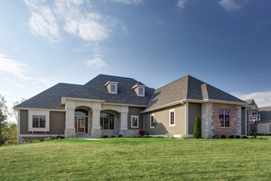 Large elegant gray two-story concrete fiberboard exterior home photo in Milwaukee
