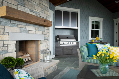 Example of a large classic backyard patio kitchen design in Minneapolis with no cover