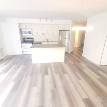Open Condo Kitchen with White Island and Continuous Plank Floor | Toronto