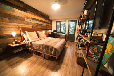 Inspiration for a mid-sized industrial master light wood floor bedroom remodel in Other with white walls