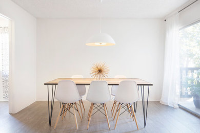 Enclosed dining room - mid-sized modern dark wood floor enclosed dining room idea in Los Angeles with white walls and no fireplace