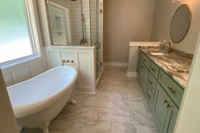 Example of a large farmhouse master white tile and subway tile double-sink, slate floor, gray floor, wainscoting and tray ceiling bathroom design in Other with shaker cabinets, green cabinets, an undermount sink, marble countertops, a hinged shower door, gray countertops, a built-in vanity and gray walls