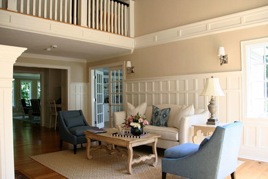 Design ideas for a mid-sized transitional foyer in Boston with beige walls and medium hardwood floors.