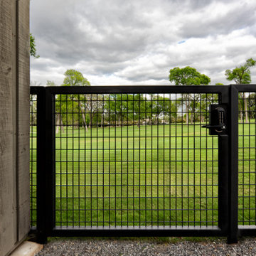Custom Metal Fence & Electric Driveway Gate with Stone Accents