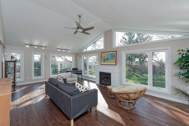 Inspiration for a large transitional open concept and formal dark wood floor and brown floor living room remodel in Toronto with a standard fireplace, a wood fireplace surround, beige walls and no tv