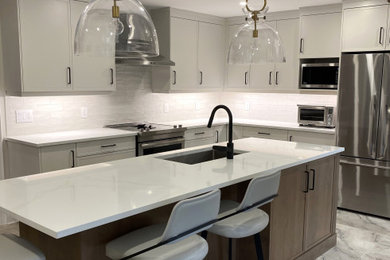 Inspiration for a mid-sized contemporary l-shaped porcelain tile eat-in kitchen remodel in Toronto with an undermount sink, flat-panel cabinets, quartz countertops, white backsplash, porcelain backsplash, stainless steel appliances, an island and white countertops
