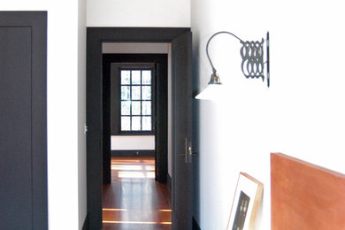 Example of an arts and crafts guest medium tone wood floor bedroom design in New York with white walls
