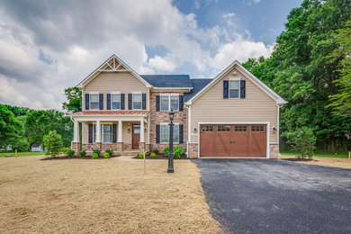 Design ideas for a mid-sized traditional two-storey beige exterior in Baltimore with mixed siding and a gable roof.