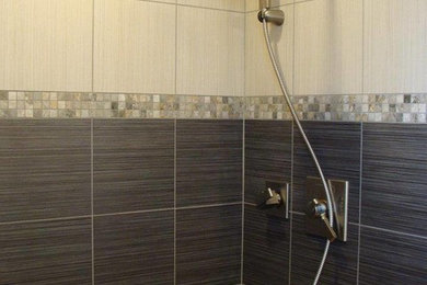 Bathroom - small modern black tile and porcelain tile porcelain tile bathroom idea in Seattle with recessed-panel cabinets, medium tone wood cabinets and tile countertops
