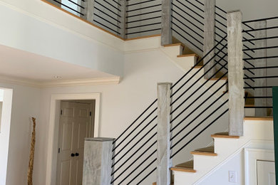 Example of a mid-sized trendy u-shaped metal railing staircase design in Houston