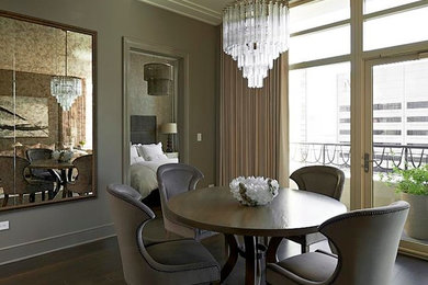 This is an example of a modern separate dining room in Chicago with beige walls and medium hardwood floors.