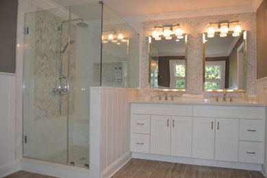Transitional master porcelain tile freestanding bathtub photo in New York with shaker cabinets, white cabinets, quartz countertops and gray walls