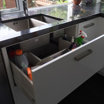Compact kitchen with Steel Grey Granite benches and gloss white cabinetry