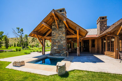 Huge mountain style brown two-story wood gable roof photo in Other