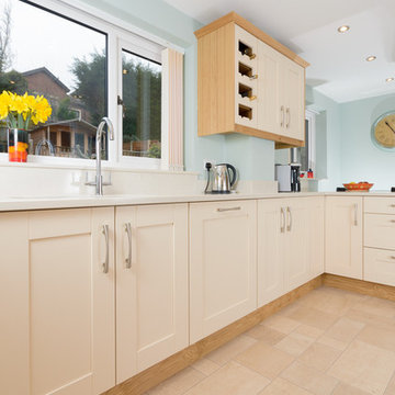 An exiting traditional kitchen with cream Shaker doors and light wood trimmings