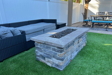 Mountain style backyard patio photo in Los Angeles with a fire pit