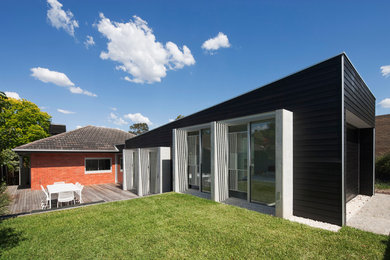 Photo of a contemporary one-storey exterior in Melbourne with wood siding.