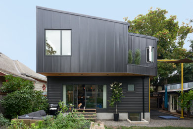 Mid-sized black two-story metal house exterior photo in Portland with a shed roof, a metal roof and a black roof