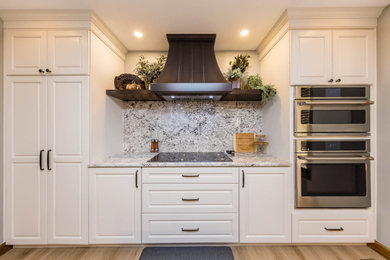 Inspiration for a large transitional u-shaped vinyl floor eat-in kitchen remodel in Columbus with an undermount sink, shaker cabinets, white cabinets, quartzite countertops, multicolored backsplash, stone slab backsplash, stainless steel appliances, two islands and multicolored countertops