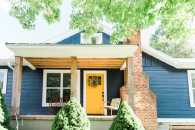 Example of a small cottage blue one-story wood exterior home design in Other
