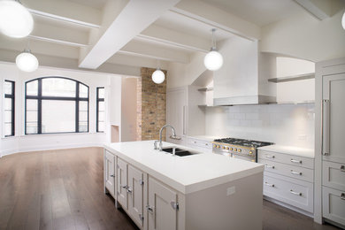 Large elegant open concept kitchen photo in Chicago with an island