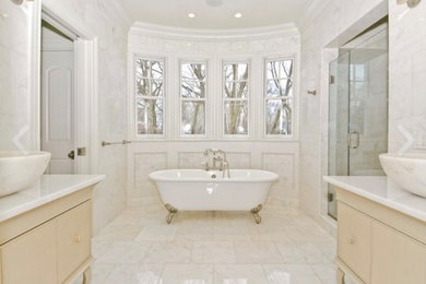 Bathroom - mid-sized traditional master white tile and stone tile marble floor bathroom idea with a vessel sink, furniture-like cabinets, light wood cabinets, marble countertops and a one-piece toilet