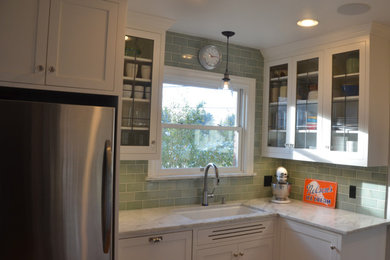 Example of a small arts and crafts u-shaped light wood floor and brown floor enclosed kitchen design in Seattle with an undermount sink, shaker cabinets, white cabinets, marble countertops, green backsplash, subway tile backsplash, stainless steel appliances, no island and white countertops