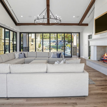 Fireside Living Room Stays Cozy Beside Folding Glass Doors in the Four-Season Pa