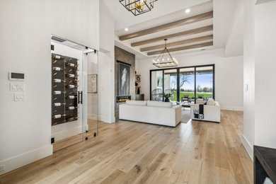 Inspiration for a large contemporary foyer in Dallas with light hardwood floors, a double front door, a black front door, white floor and exposed beam.