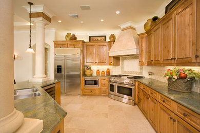Transitional limestone floor eat-in kitchen photo in Houston with a double-bowl sink, raised-panel cabinets, light wood cabinets, granite countertops, beige backsplash, subway tile backsplash, stainless steel appliances and an island