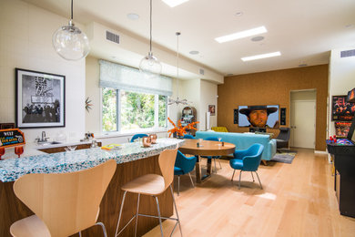 Example of a large 1960s enclosed light wood floor home theater design with white walls and a wall-mounted tv