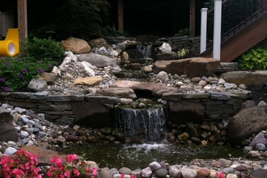 This is an example of a small contemporary full sun front yard stone water fountain landscape in Philadelphia for summer.