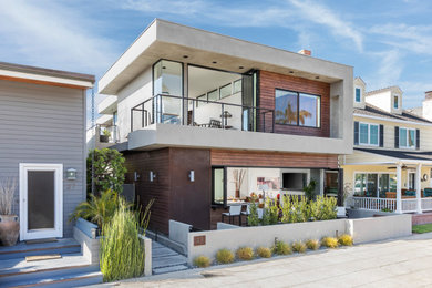 Large minimalist brown two-story metal and clapboard exterior home photo in Los Angeles with a green roof and a white roof